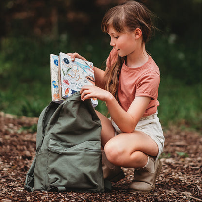 Girl with wild activity book and backpack